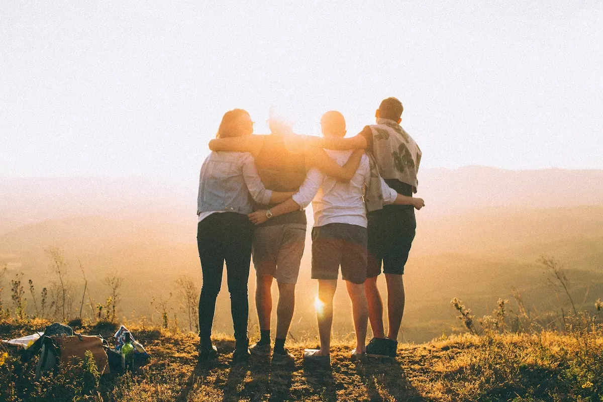 A group of four people on top of a cliff