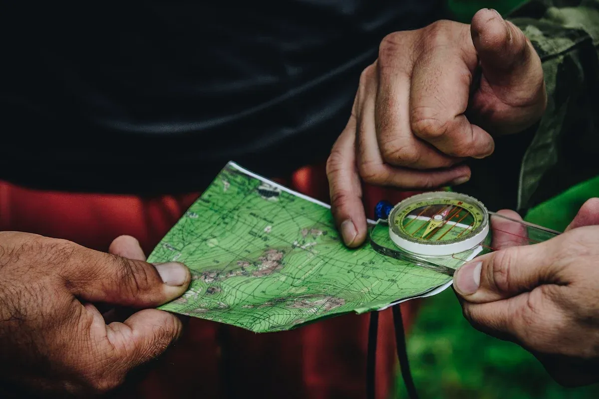 Two people finding their way with a map and compass